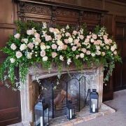 Pink and white rose fireplace arrangement 